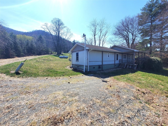 exterior space with covered porch and a front yard