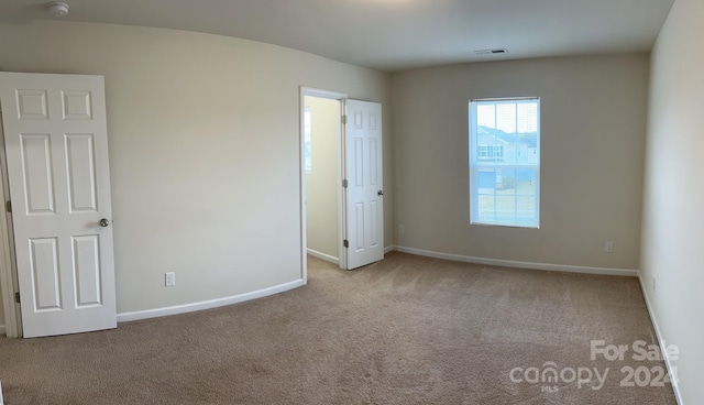 unfurnished bedroom with light carpet