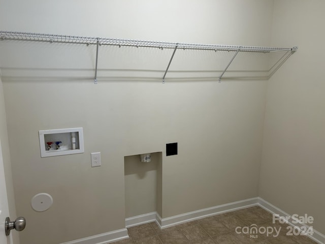 washroom with tile floors and hookup for a washing machine