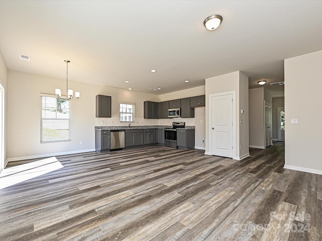 kitchen with dark wood-style flooring, open floor plan, light countertops, appliances with stainless steel finishes, and gray cabinets