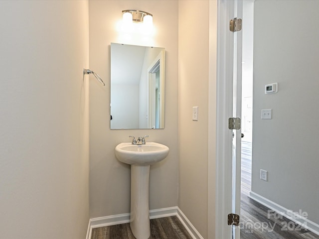 bathroom with hardwood / wood-style flooring and sink