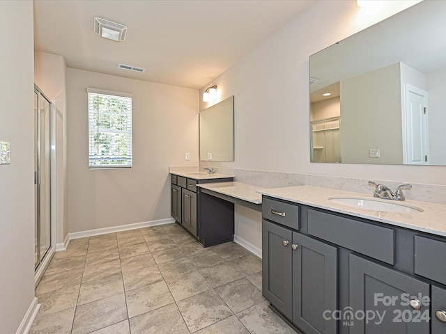 bathroom featuring vanity and a shower with shower door