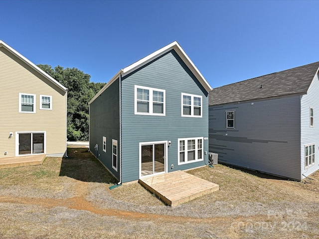 back of property featuring central AC