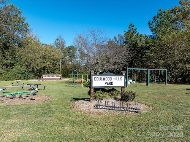 view of home's community featuring playground community and a yard