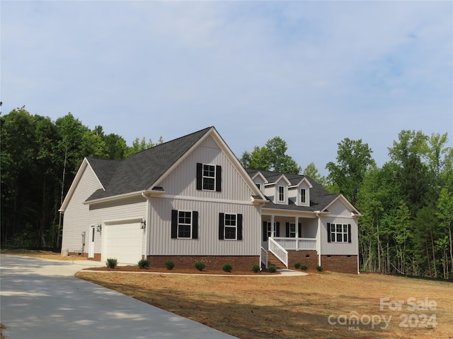 view of front of home featuring a porch and a garage