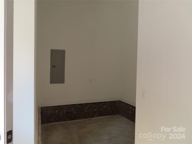 interior space featuring electric panel and concrete floors