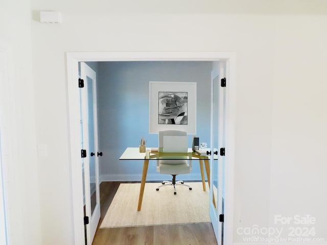 home office with hardwood / wood-style flooring