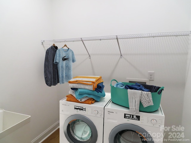 clothes washing area with sink and independent washer and dryer