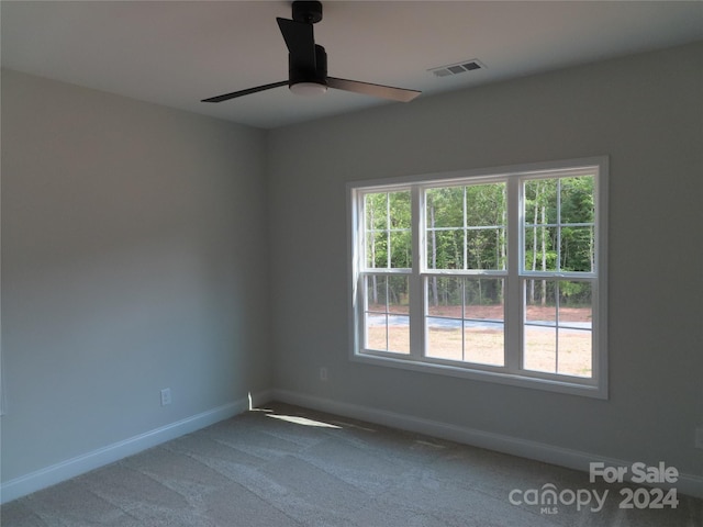 empty room with ceiling fan and carpet flooring