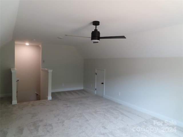 additional living space featuring ceiling fan, light colored carpet, and lofted ceiling