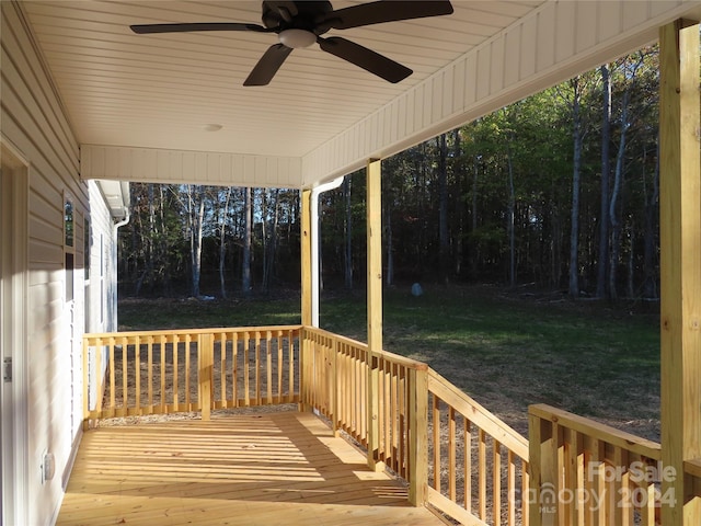 deck featuring ceiling fan and a lawn