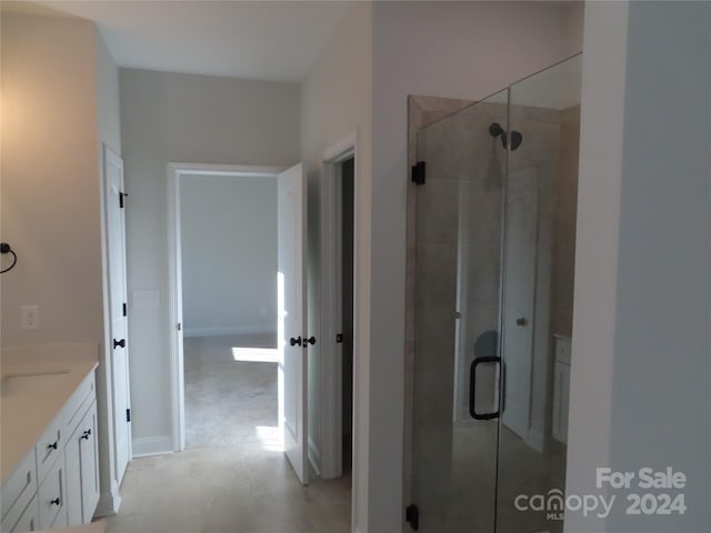 bathroom featuring an enclosed shower and vanity