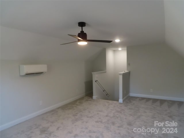 bonus room featuring ceiling fan, light colored carpet, a wall mounted AC, and vaulted ceiling