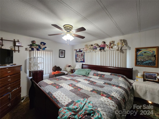 bedroom with a textured ceiling, ceiling fan, and carpet floors