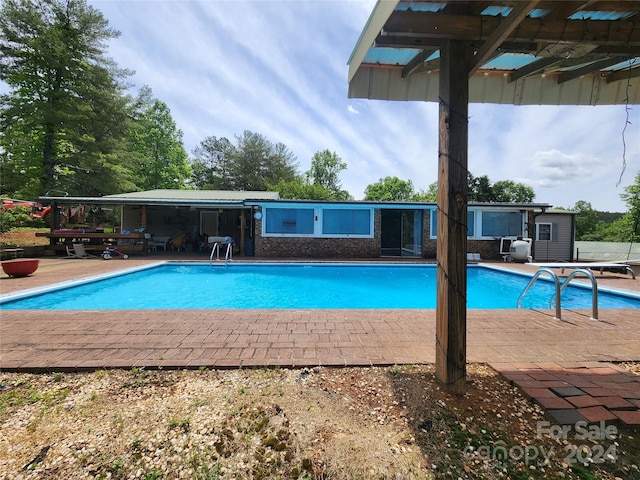 view of swimming pool with a patio