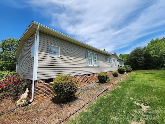 view of side of home featuring a yard