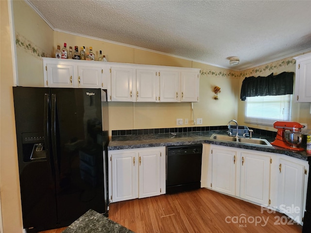 kitchen with white cabinets, sink, light hardwood / wood-style flooring, and black appliances