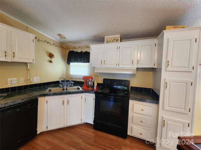 kitchen featuring sink, white cabinetry, black appliances, and hardwood / wood-style floors