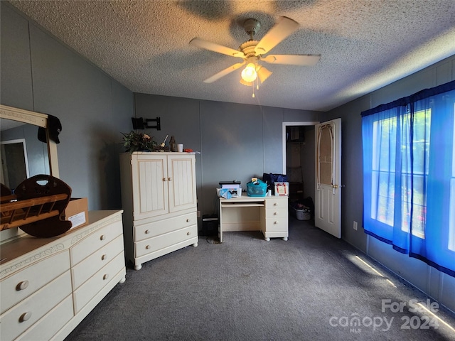 carpeted bedroom with a textured ceiling and ceiling fan