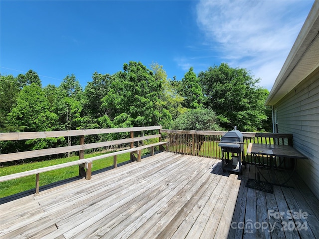 wooden terrace featuring grilling area