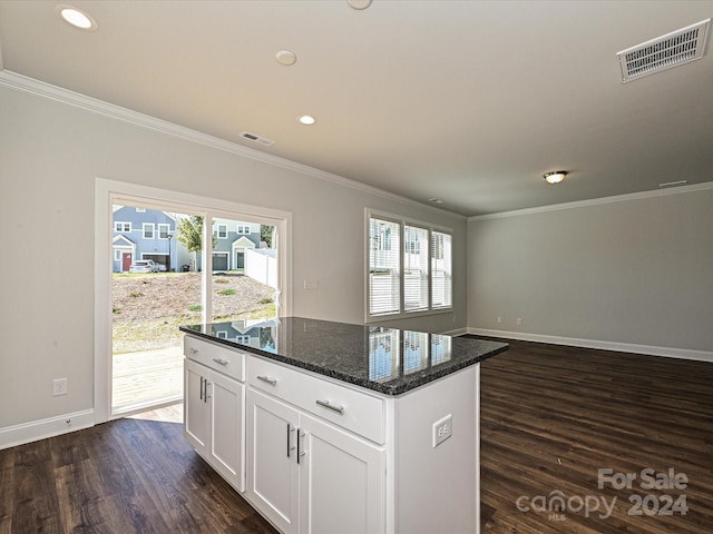 kitchen with white cabinetry, visible vents, dark wood finished floors, and dark stone countertops