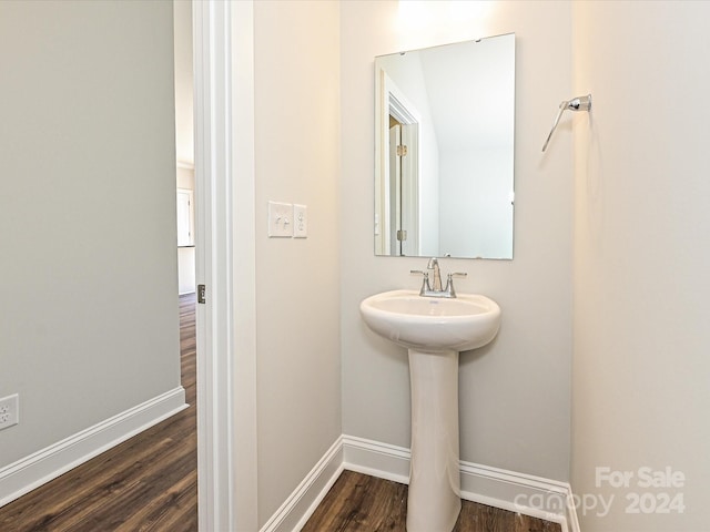 bathroom with wood finished floors and baseboards