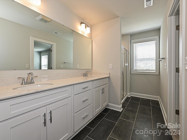 full bath with double vanity, visible vents, a sink, and tile patterned floors