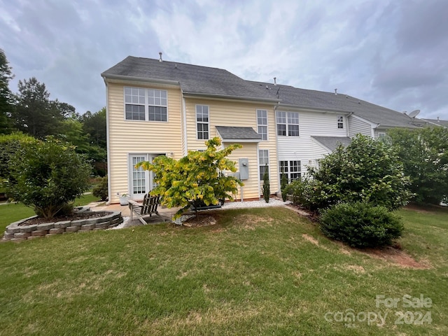 rear view of property with a patio area and a yard