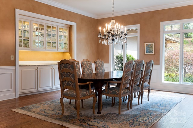 dining room with dark hardwood / wood-style flooring, a wealth of natural light, and a chandelier