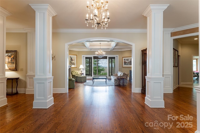 foyer with beam ceiling, an inviting chandelier, crown molding, coffered ceiling, and ornate columns