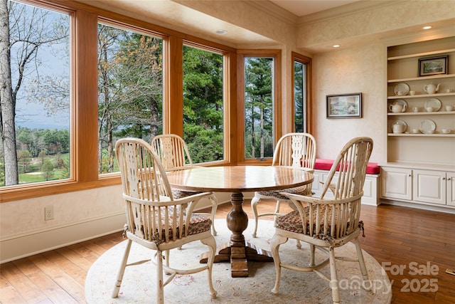 dining area featuring dark wood-type flooring and built in features