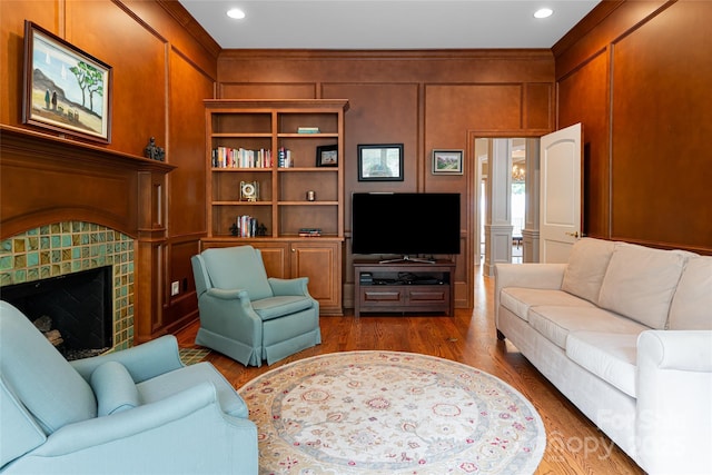 living room with ornamental molding and hardwood / wood-style flooring