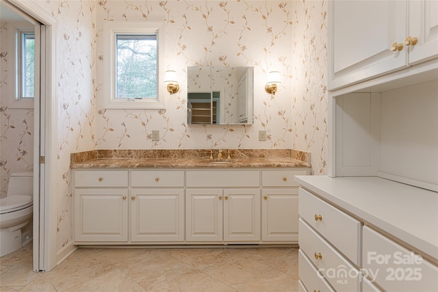 bathroom featuring toilet, vanity, and tile patterned flooring