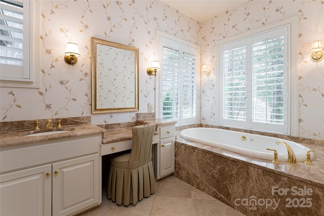 bathroom featuring tiled tub, vanity, and tile patterned flooring