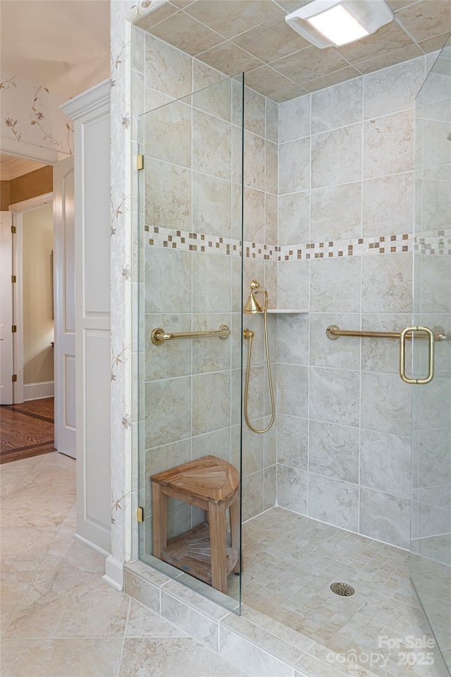 bathroom featuring a shower with door