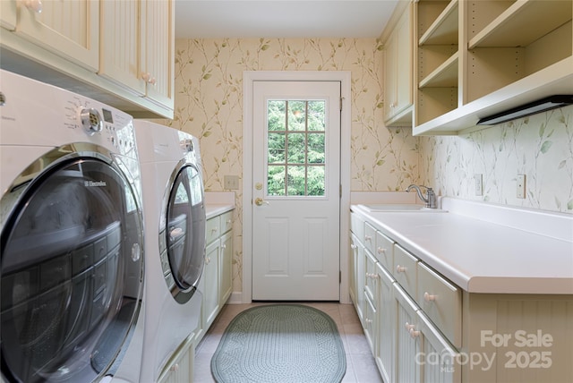 laundry room with cabinets, light tile patterned flooring, separate washer and dryer, and sink