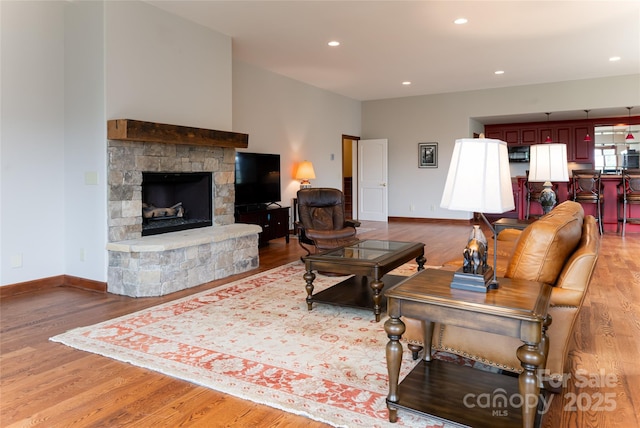 living room featuring light hardwood / wood-style floors and a fireplace