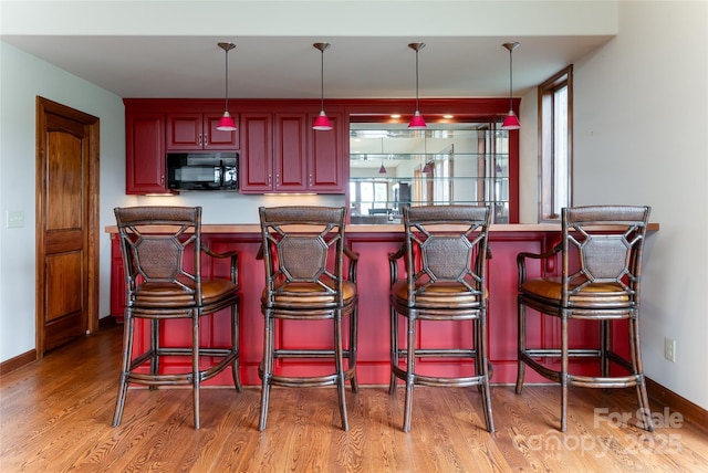 kitchen with pendant lighting and hardwood / wood-style flooring