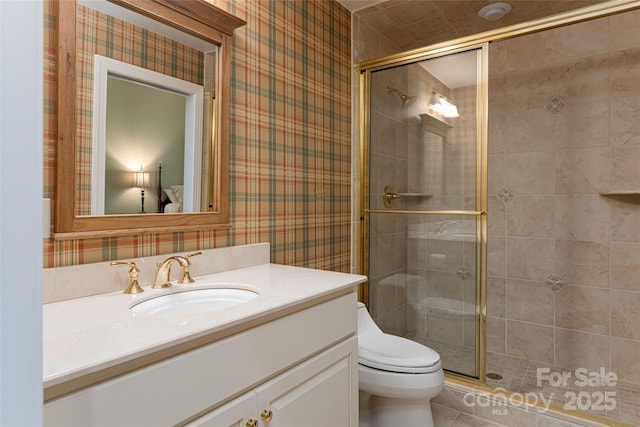 bathroom featuring an enclosed shower, vanity, and toilet