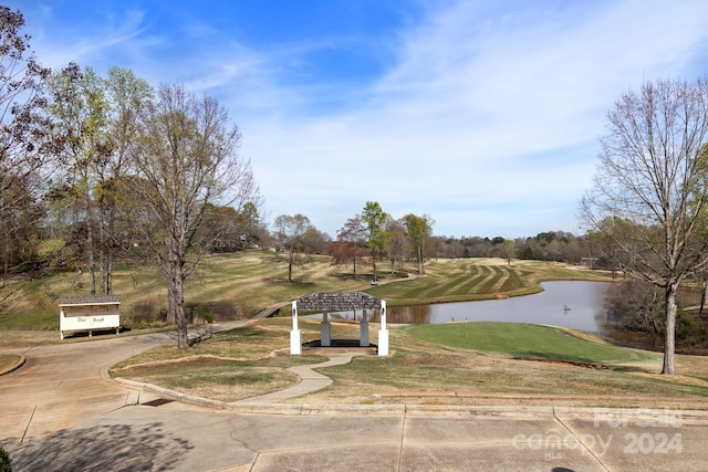 view of front of property with a gazebo, a front yard, and a water view