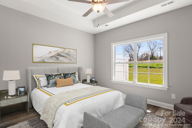 bedroom with ceiling fan and dark wood-type flooring