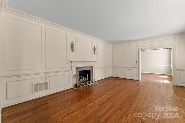 unfurnished living room with a premium fireplace and wood-type flooring