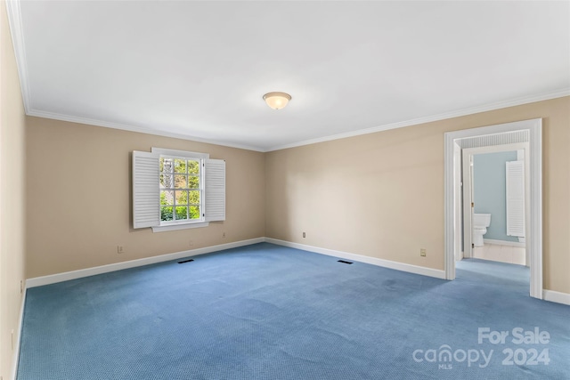 unfurnished room with dark carpet and ornamental molding