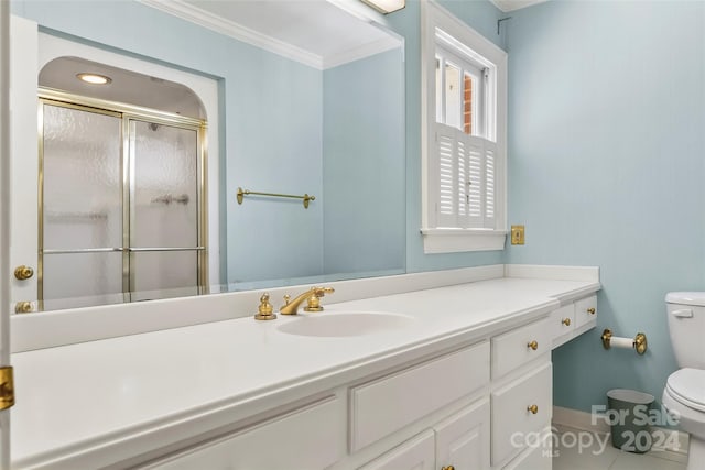 bathroom with crown molding, toilet, and large vanity