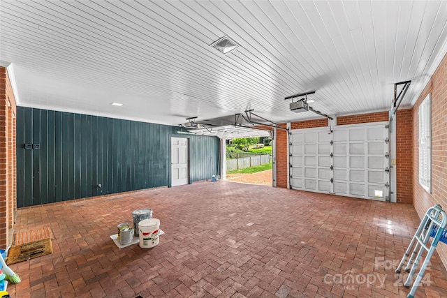 garage with a garage door opener and wood ceiling