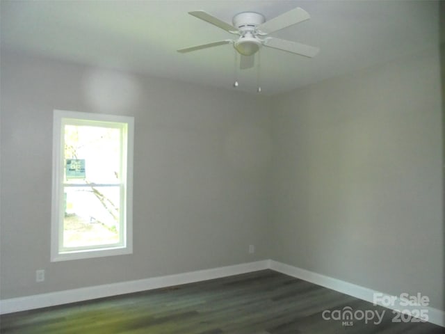 unfurnished room with dark wood-type flooring and ceiling fan