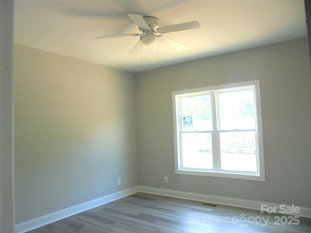 empty room featuring wood-type flooring and ceiling fan