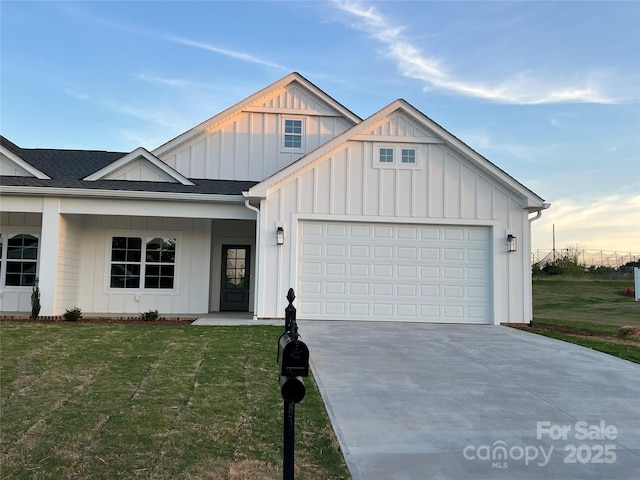 view of front of home with a garage and a lawn