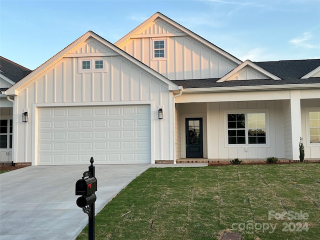 view of front of home with a front lawn and a garage