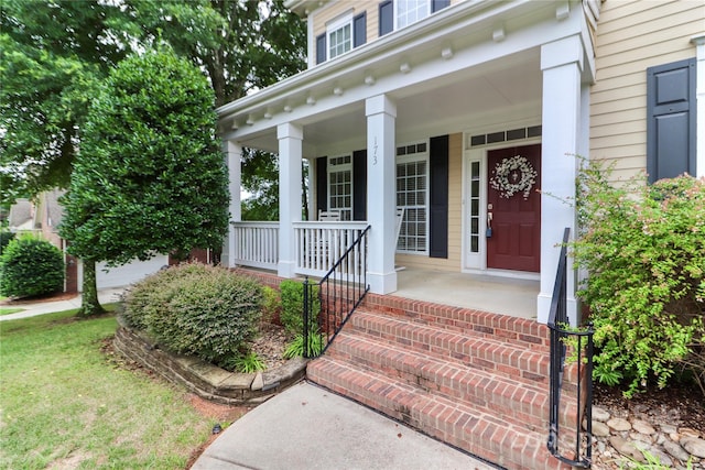 view of exterior entry featuring a porch